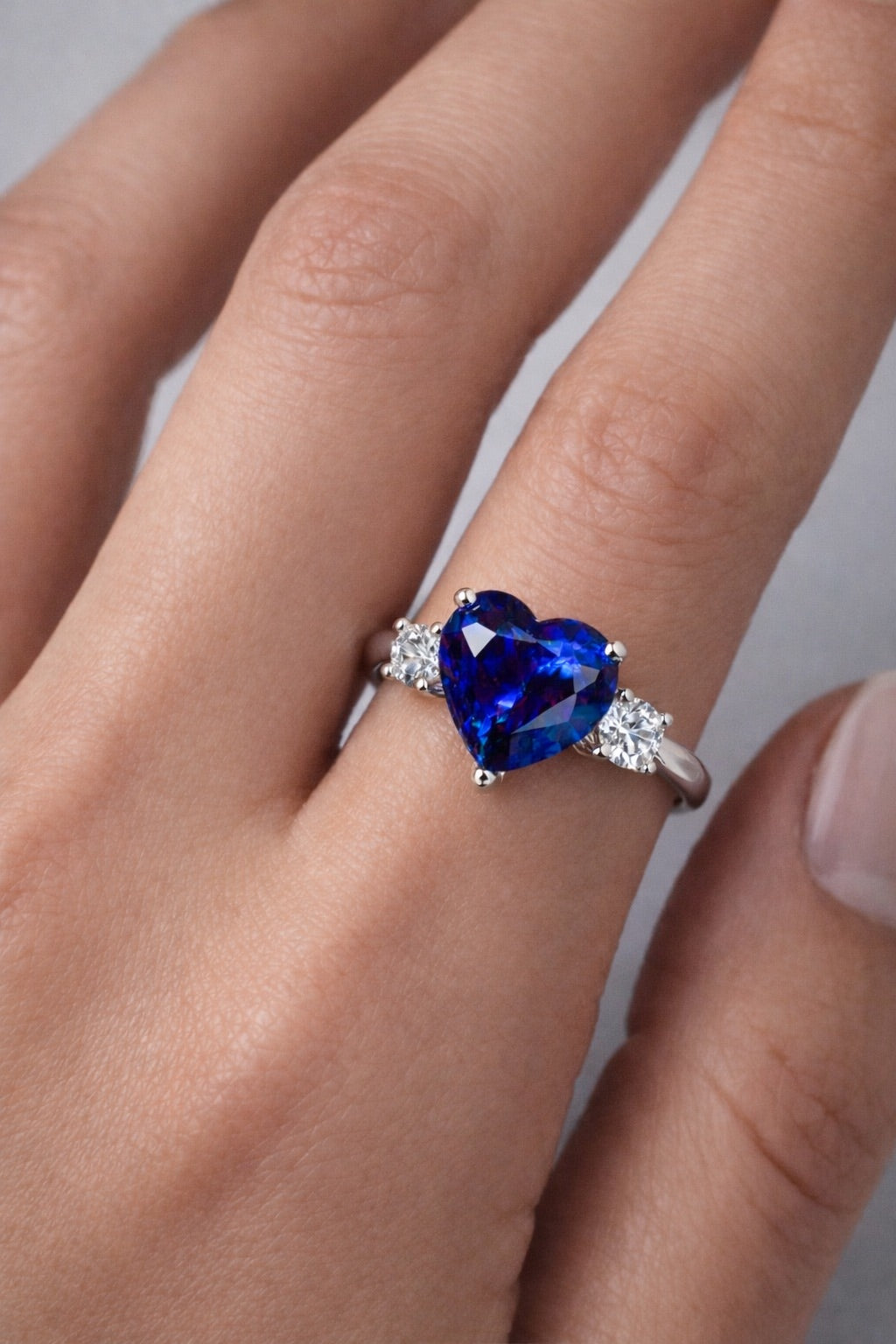 Eternal Heart blue sapphire three-stone ring in white gold on finger