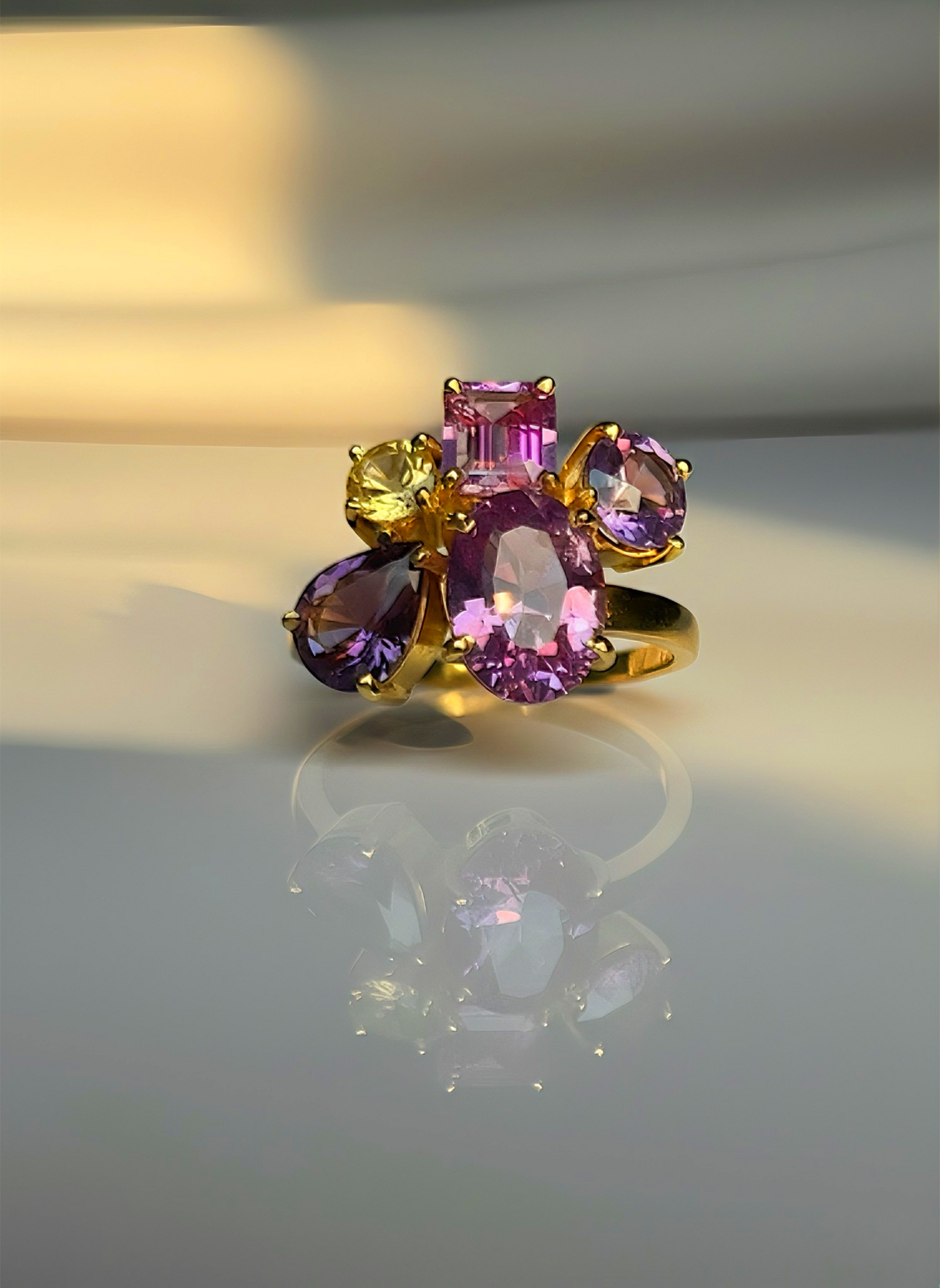 Unheated violet and pink sapphire ring with yellow sapphire accent