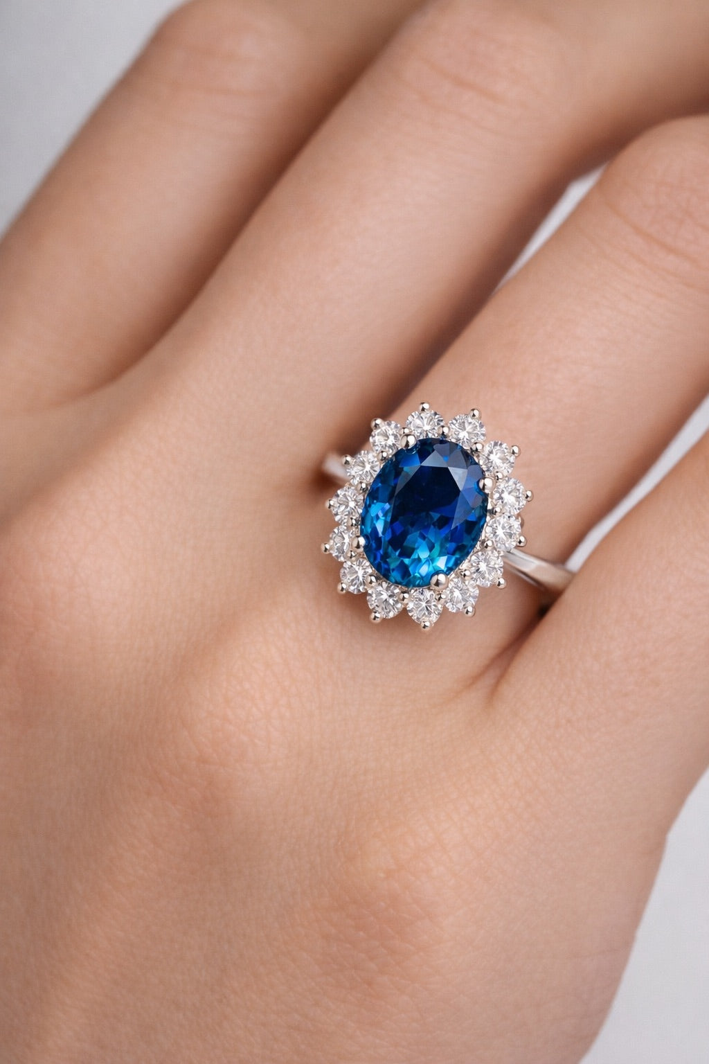 Unheated blue sapphire halo ring in white gold on hand